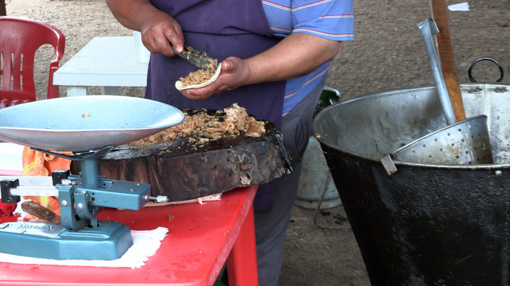 A man preparing tacos